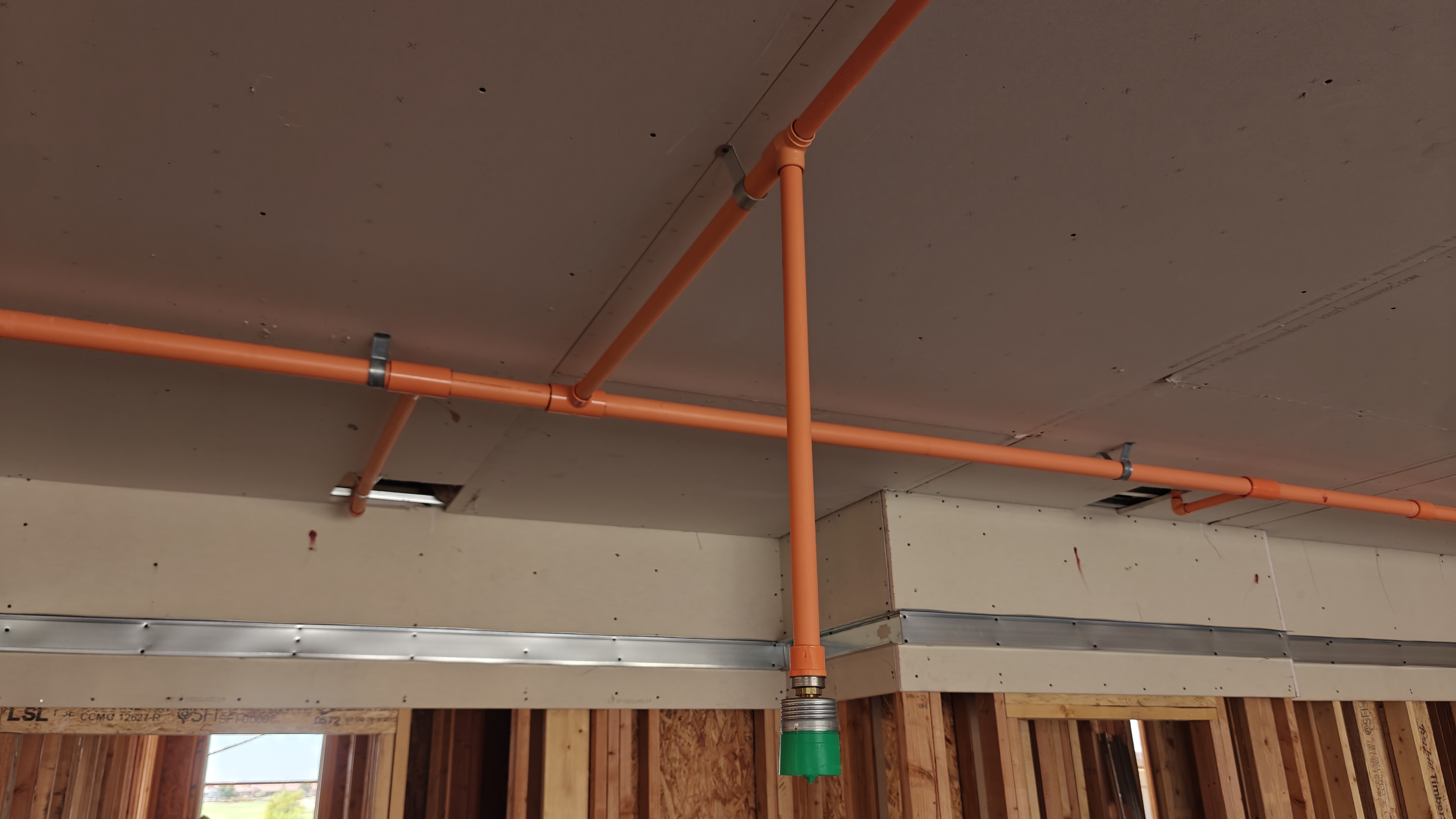 Fire protection control valves, gauges, and connected orange piping